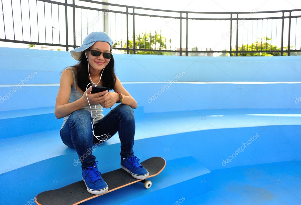 Woman listening player on skatepark