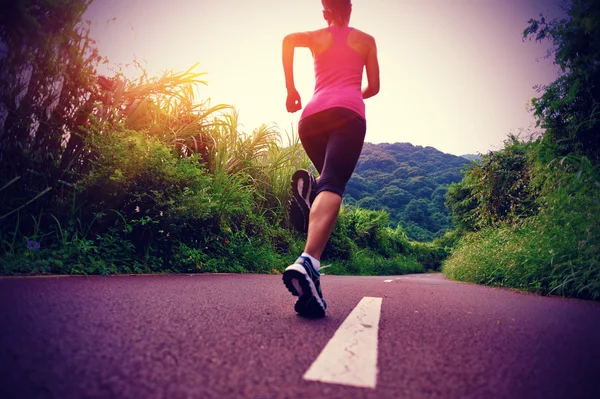 Athlete running on road — Stock Photo, Image