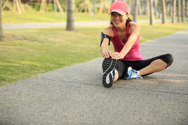 Woman runner stretching legs outdoor — Stock Photo, Image