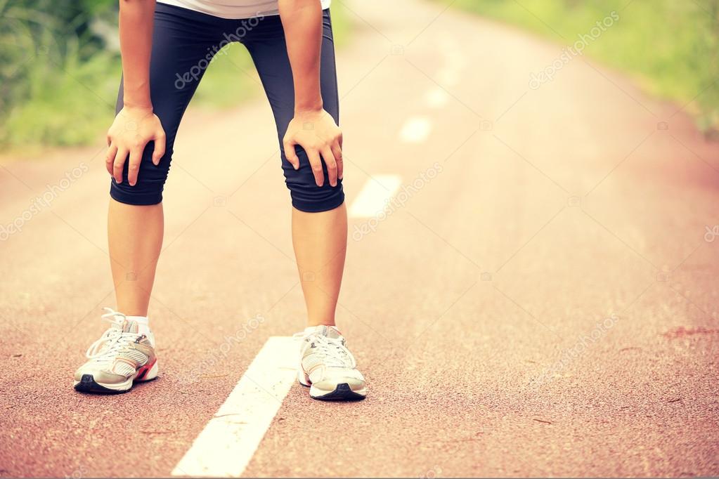 Depositphotos 58770635 stock photo tired female runner taking a