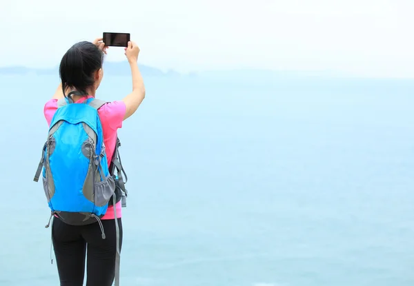 Young woman hiker taking photo — Stock Photo, Image