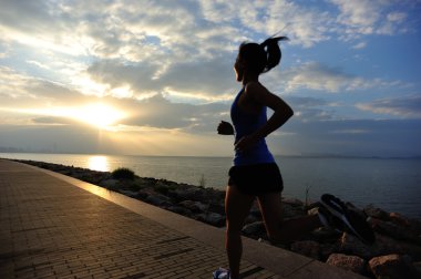 Runner athlete running at seaside. woman fitness silhouette sunrise jogging workout wellness concept. clipart