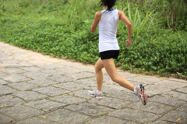 Young fitness asian woman running at forest trail — Stock Photo, Image