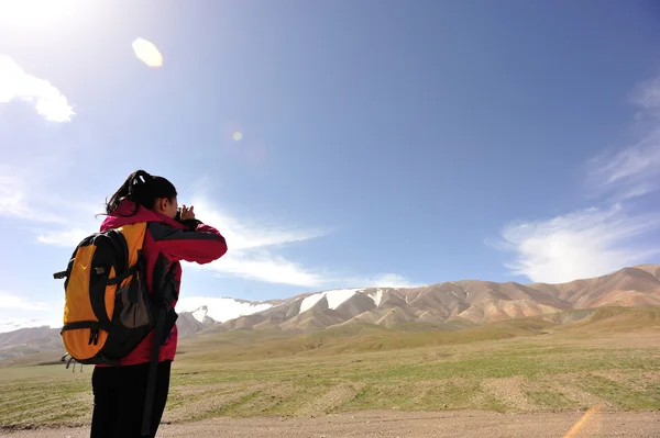 チベットで写真を撮る女性使用スマート フォンをハイキング — ストック写真