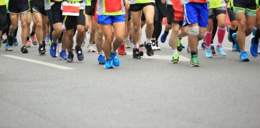 Maraton koşusu, insanlar şehir yolunda yürüyor.