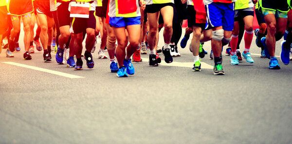 Marathon running race, people feet on city road