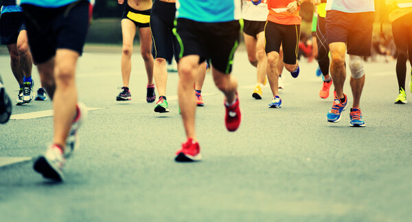 Marathon running race, people feet on city road