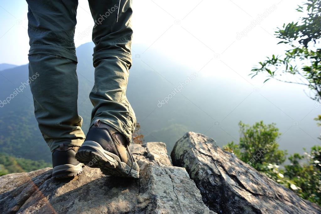 Female legs on mountain top