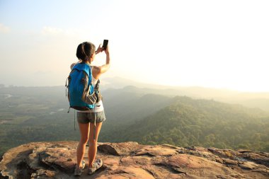 Uzun yürüyüşe çıkan kimse smartphone ile dağ üst