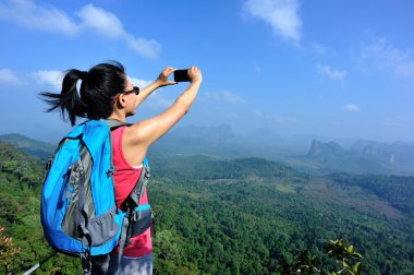 Uzun yürüyüşe çıkan kimse smartphone ile dağ üst