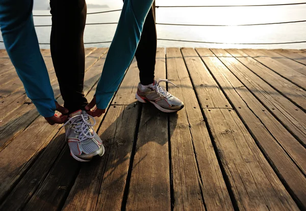 Kvinnliga löpare knyta skosnören — Stockfoto