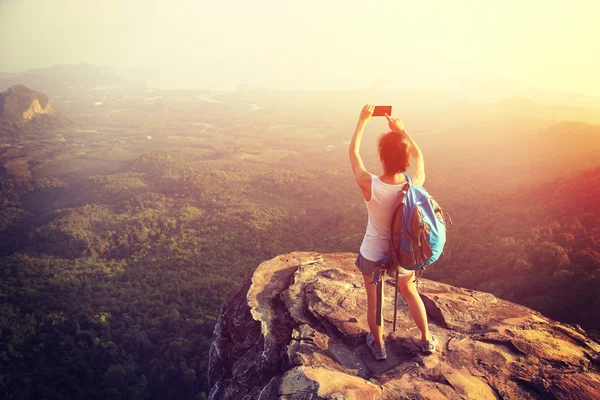 Mulher turista tirar foto top montanha — Fotografia de Stock