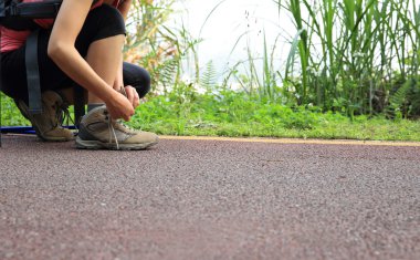 Kadın uzun yürüyüşe çıkan kimse bağlama ayakkabı bağı