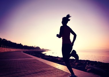 Deniz kenarında koşan bayan sporcu