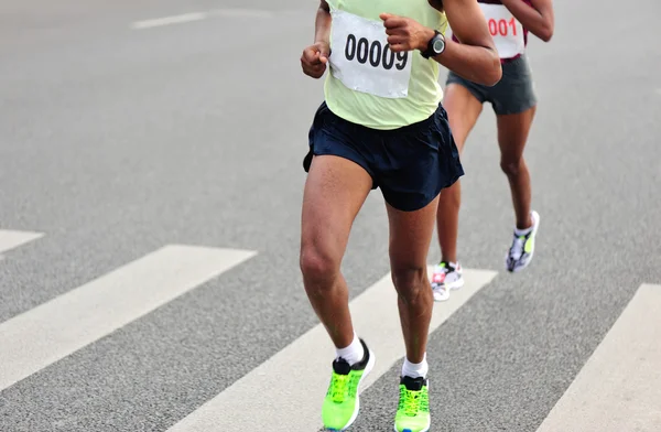 Marathon athletes running on road — Stock Photo, Image