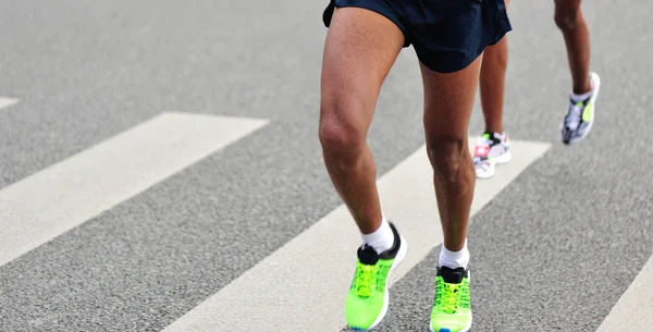 Marathon athletes running on road — Stock Photo, Image