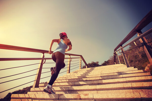 Sporty woman running up stairs
