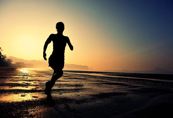 Female running silhouette at beach — Stock Photo, Image