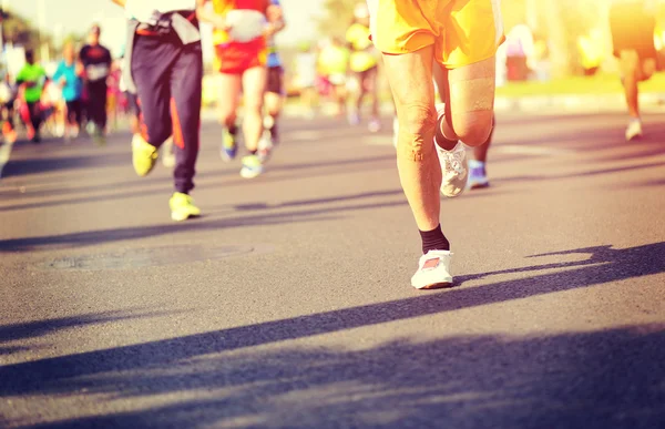 Marathon athletes legs running on road — Stock Photo, Image