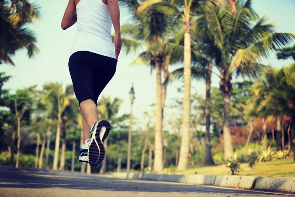 Runner athlete running at tropical park — Stock Photo, Image