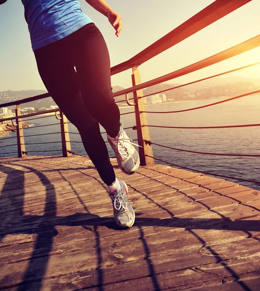 Healthy lifestyle woman running on boardwalk — Stock Photo, Image