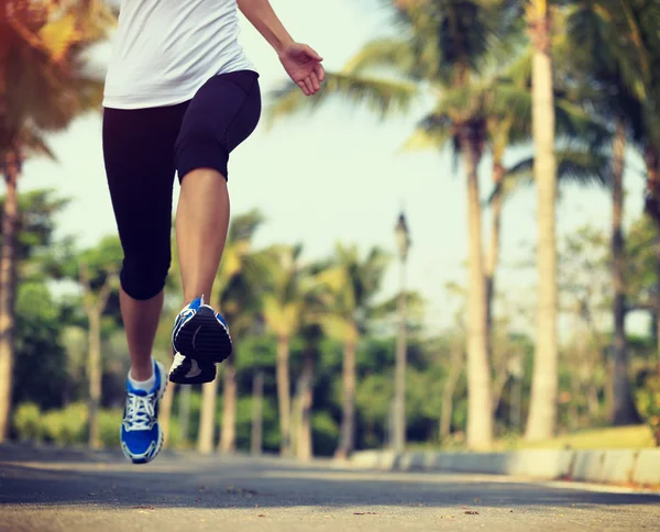 Vrouwelijke jogger benen draait op park. — Stockfoto