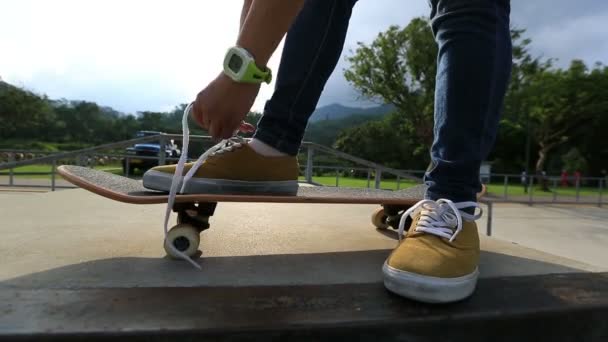 Skateboardista vázání tkaničky — Stock video