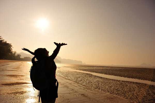 Cheering young woman hiker