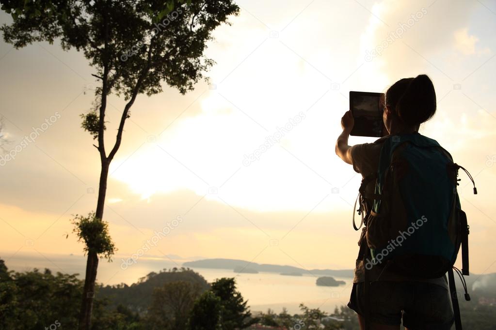 woman hiker with digital tablet