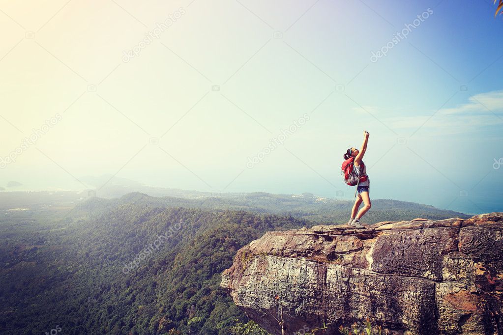woman hiker taking photo with phone