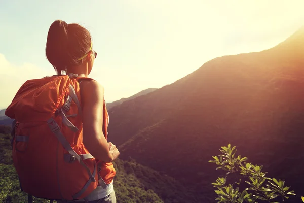 Mujer mochilero en pico de montaña — Foto de Stock