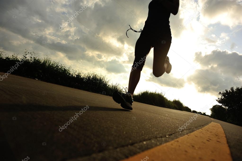 Runner athlete running at seaside road