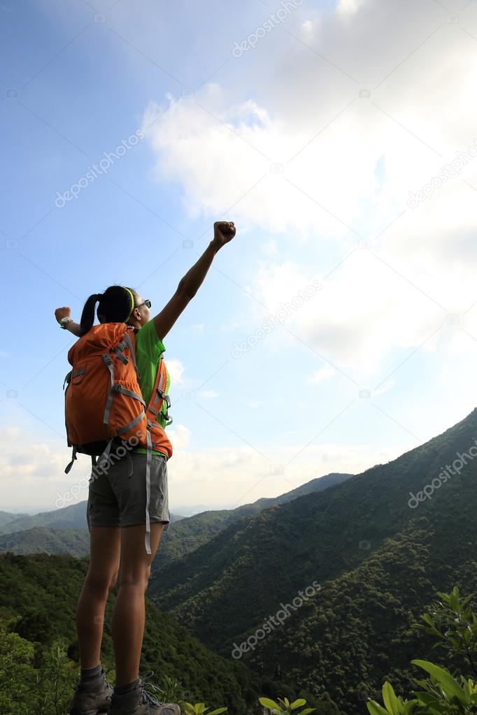 Cheering woman hiker