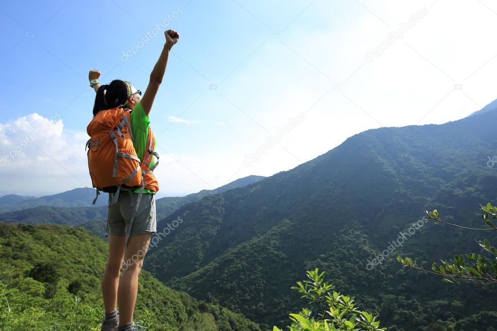 Cheering woman hiker