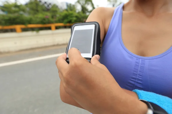 Female Runner with smart phone player — Stock Photo, Image