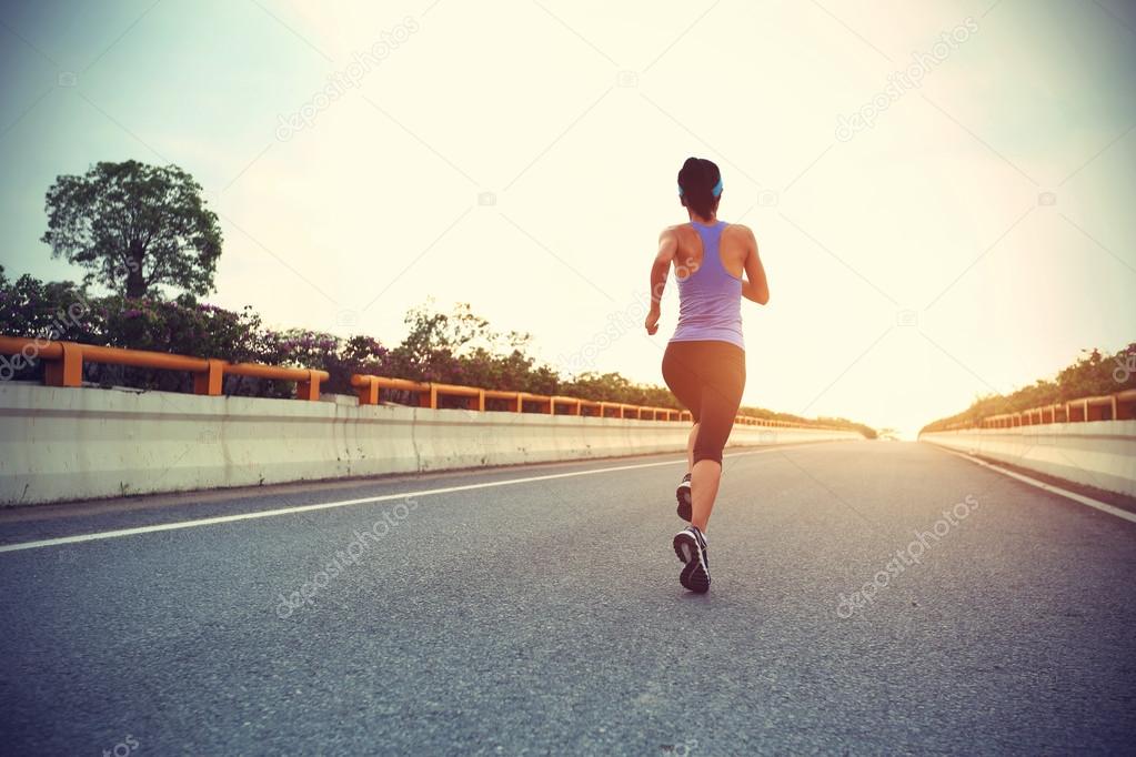 Woman running on city road