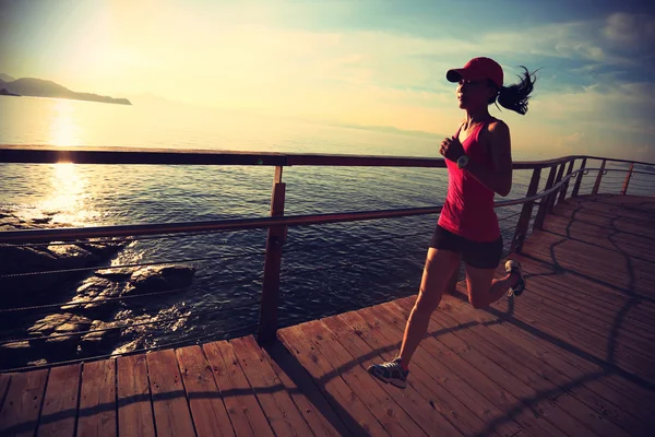 Sporty female running on boardwalk — Stock Photo, Image