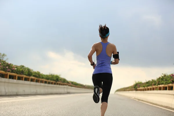 Woman running on road — Stock Photo, Image