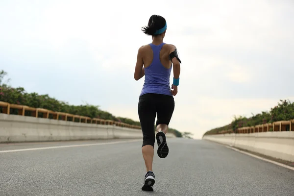 Woman running on road — Stock Photo, Image