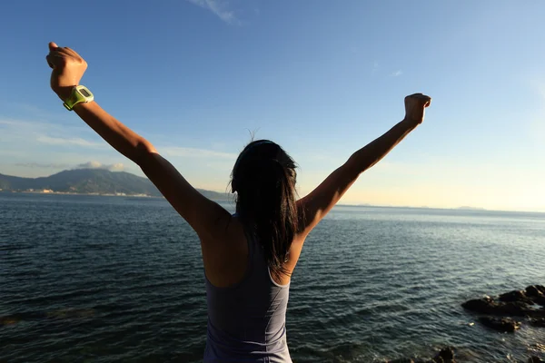 Young woman jogger open arms