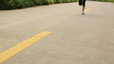 woman running on seaside trail