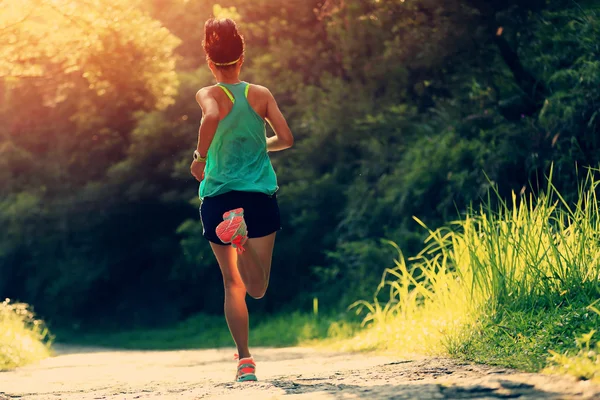 Runner athlete running on forest trail