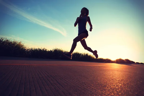 Junge Fitness-Frau läuft bei Sonnenaufgang — Stockfoto