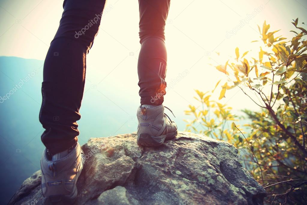Young woman hiker legs on mountain