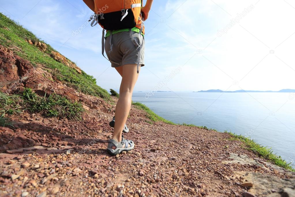 Young woman backpacker  on seaside