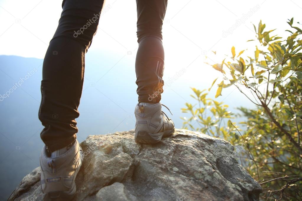 Young woman hiker legs on mountain