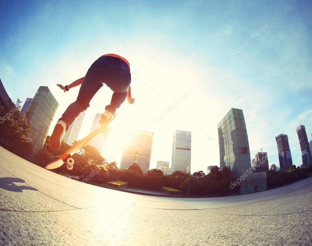 female skateboarding at city
