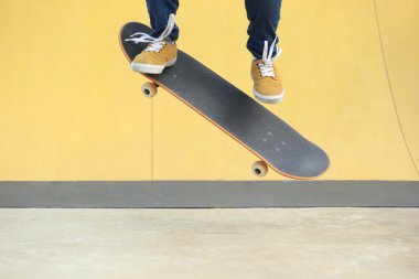 female Skateboarding at skatepark clipart