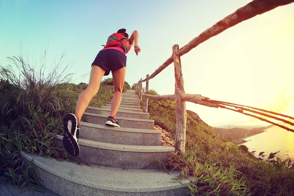 Fitness woman running up stairs — Stock Photo, Image