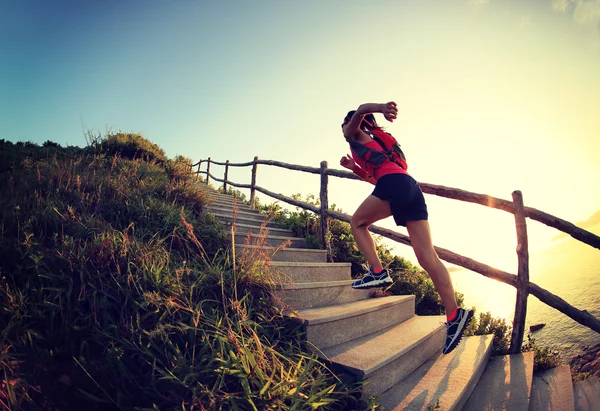 Fitness woman running up stairs — Stock Photo, Image